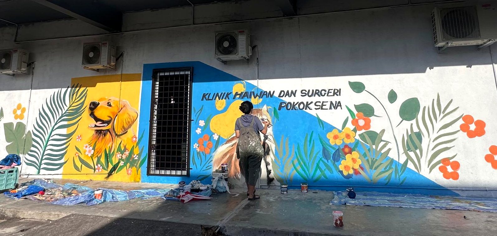Wide exterior animal mural for a pet clinic facade