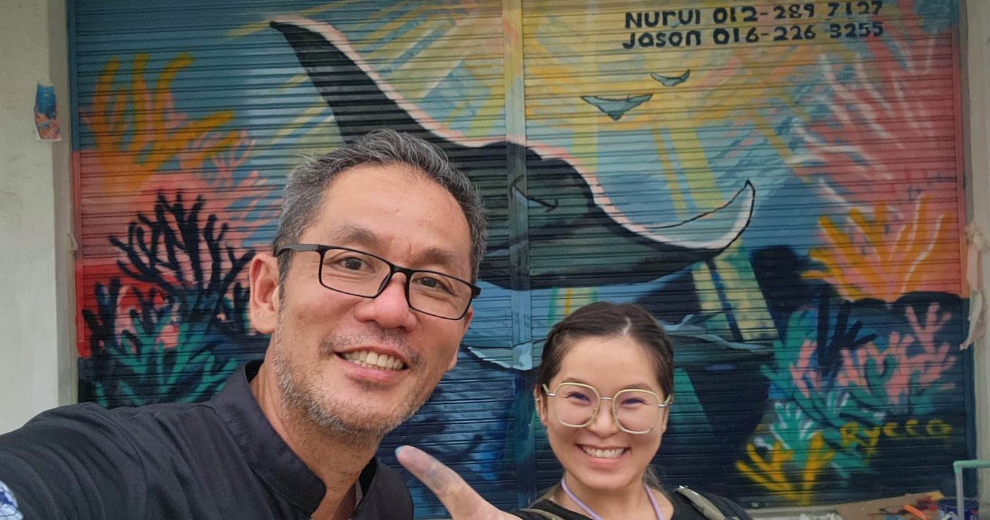 Finished shopfront whale mural with team photo