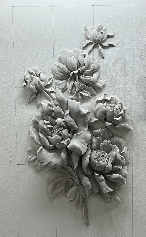 Unpainted peony relief showing raised petals and leaves